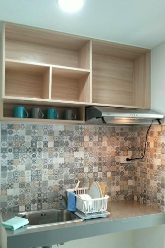 a kitchen counter with a sink and some cabinets at beHOME Phuket in Nai Yang Beach