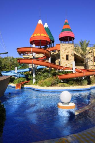 a water park with a water slide in front of it at AQI Pegasos Royal in Avsallar