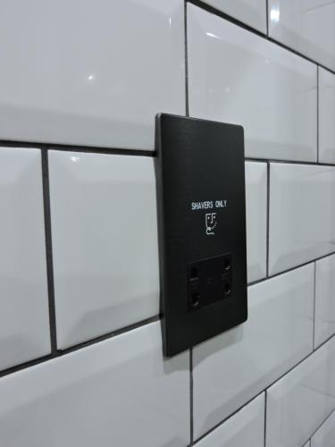 a soap dispenser on a bathroom tiled wall at Scafell View Apartment, Wasdale, Lake District, Cumbria in Nether Wasdale