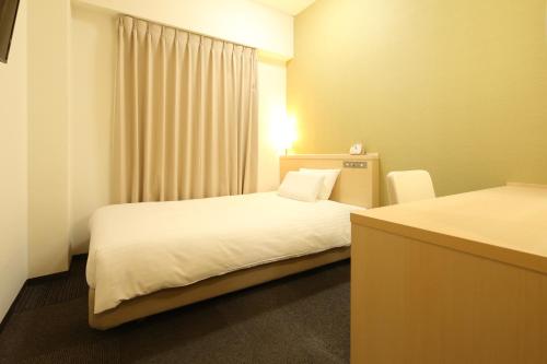 a hotel room with two beds and a window at AB Hotel Mikawa Anjo Honkan in Anjo