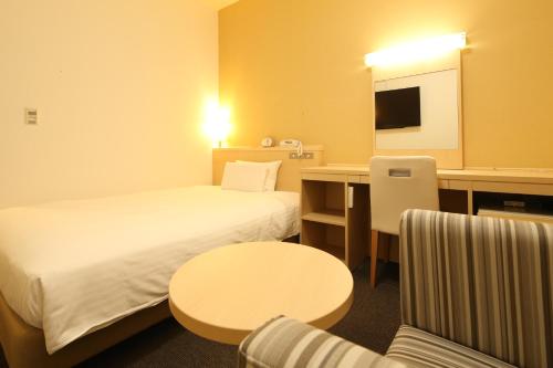 a hotel room with two beds and a table at AB Hotel Mikawa Anjo Honkan in Anjo
