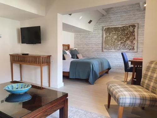 a hotel room with a bed and a table at Great Fosters - Near Windsor in Egham