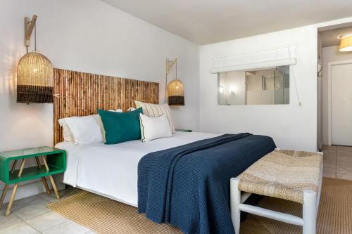 a bedroom with a large white bed and a mirror at Lagoon Attitude (Adults Only) in Cap Malheureux