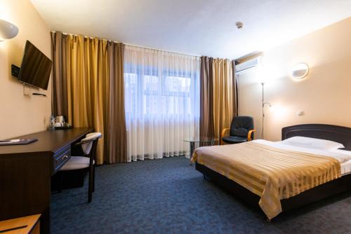 Un pat sau paturi într-o cameră la IBB Hotel