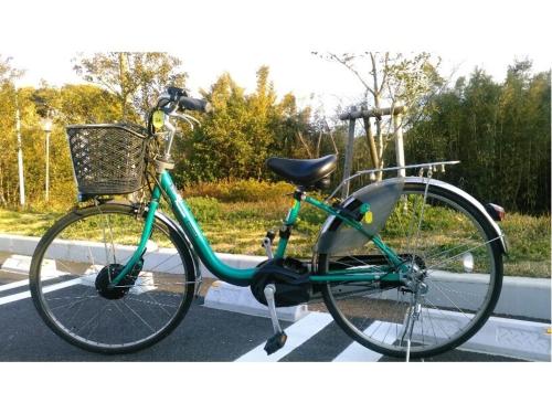 a green bike parked on the side of a street at Ikijimaso in Iki