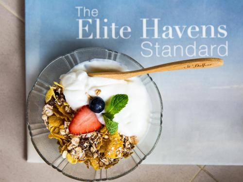 a book cover of the elite hawkers standard with a bowl of dessert at Baan Puri - SHA Extra Plus in Lipa Noi