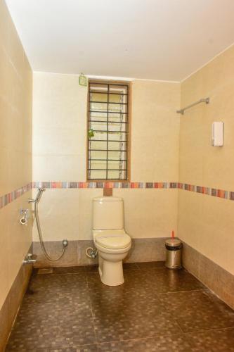 a bathroom with a toilet and a shower at Surya Kiran Miramar in Panaji
