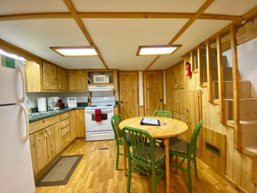 a kitchen with a table and chairs and a refrigerator at Maggie Valley Cabin Rentals in Maggie Valley