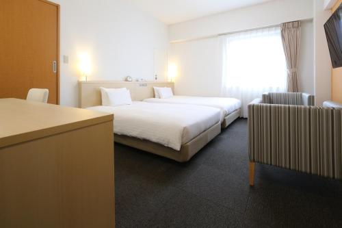 a hotel room with a large bed and a window at AB Hotel Mikawa Anjo Honkan in Anjo