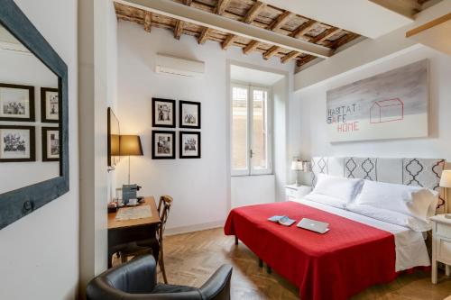 a bedroom with a red bed and a desk at The Bluehostel in Rome