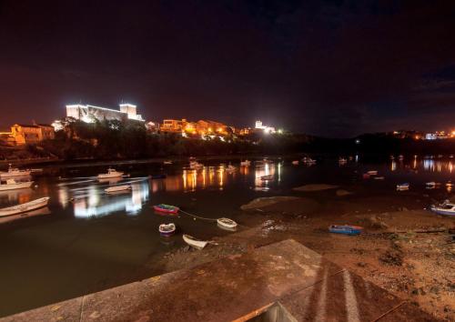 a harbor at night with boats in the water at La Arcadia de Portillo in Portillo