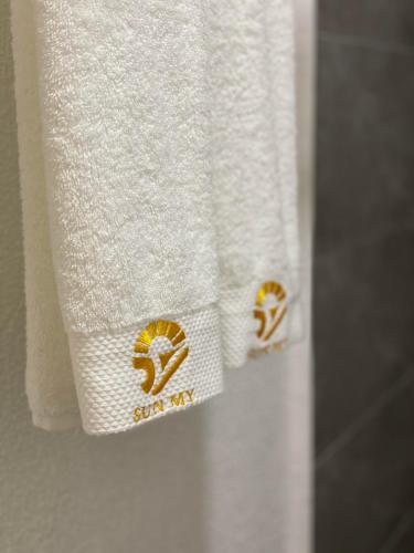 a close up of towels on a bathroom door at SUN MY HOTEL in Davao City