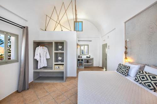 a bedroom with a white bed and a window at Kalya Suites in Kamari