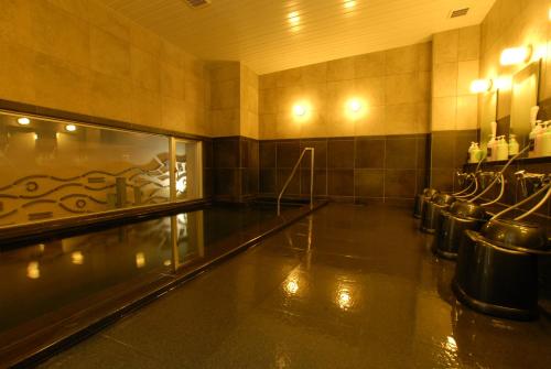 a bowling alley with a bunch of seats in a room at AB Hotel Nagoya Sakae in Nagoya