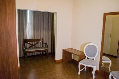a room with a table and a chair and a desk at POUSADA ESTÂNCIA in Penedo