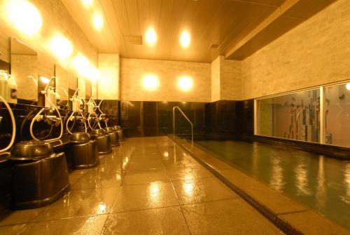 a swimming pool with a row of mirrors in a building at AB Hotel Toyohashi in Toyohashi