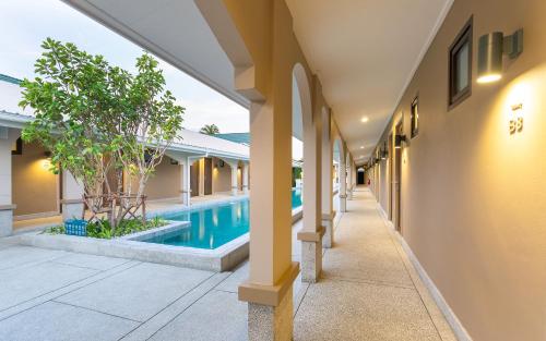 a corridor of a building with a swimming pool at BARA BARA' Budget SATUN 'SHA Plus' in Satun