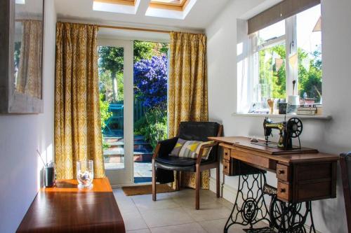 a home office with a desk and a window at Guillemot in Beaumaris