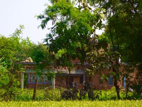 an old brick building with a sign on it at Maji Homestay Khajuraho in Khajurāho
