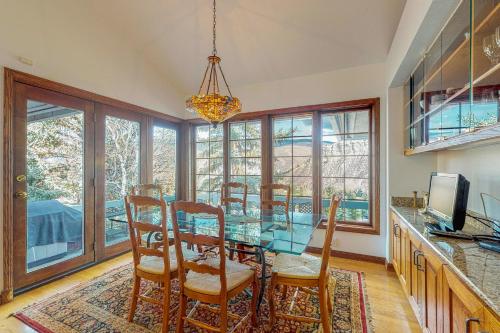 a dining room with a glass table and chairs at Wayne Creek Residence in Avon