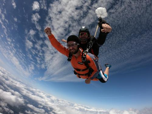 two men are jumping in the sky with their arms in the air at Landlust Hotel in Gransee