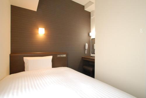 Ένα ή περισσότερα κρεβάτια σε δωμάτιο στο AB Hotel Iwata