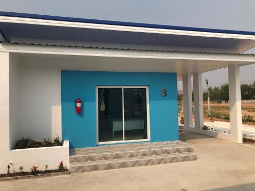 a blue and white building with a window at SiRi Resort in Maha Sarakham