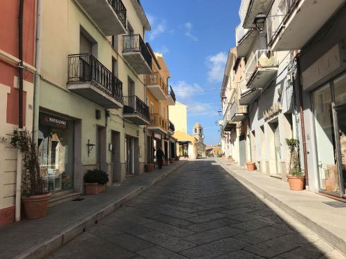 an empty street in a city with buildings at Casa Lu Duttori in Arzachena