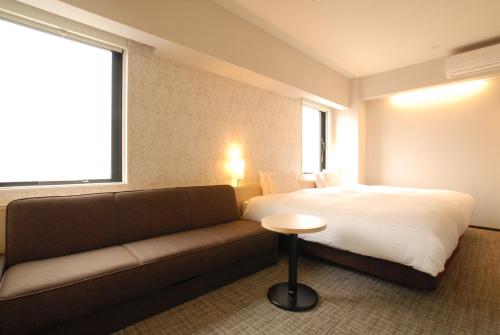 Postel nebo postele na pokoji v ubytování AB Hotel Fuji