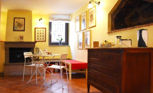 a kitchen with a table and chairs and a dining room at Il Peperino GuestHouse in Viterbo