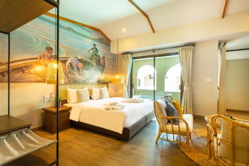a hotel room with a bed and a painting on the wall at BARA BARA' Budget SATUN 'SHA Plus' in Satun