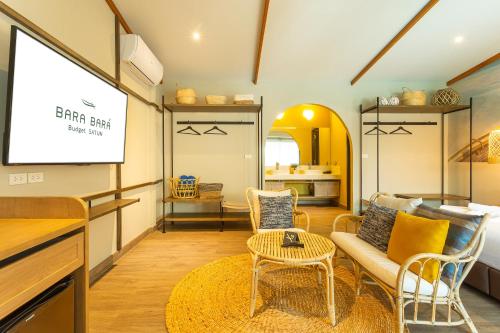 a living room with a projector screen and a couch at BARA BARA' Budget SATUN 'SHA Plus' in Satun
