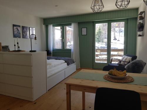 a bedroom with a bed and a table in it at Studio - Cosy et central, Haute-Nendaz, 4 Vallées in Nendaz