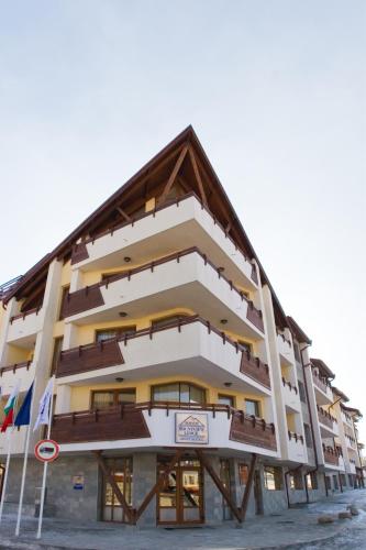 a building with balconies on the side of it at Mountview Lodge Apartments in Bansko