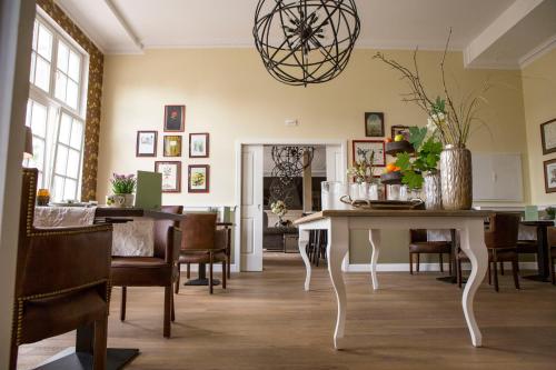 a dining room with a table and chairs at The Starnbergsee Hideaway in Seeshaupt