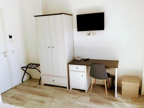 a room with a desk and a cabinet and a computer at Pigneto Guest House in Rome
