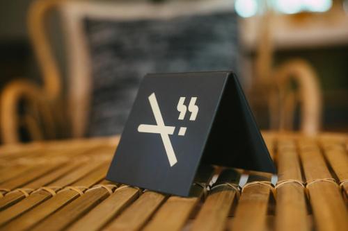 a black sign sitting on top of a wooden table at BARA BARA' Budget SATUN 'SHA Plus' in Satun