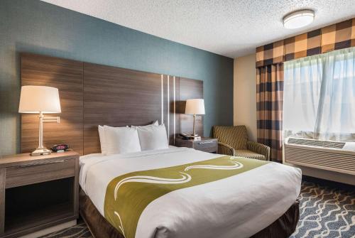 a hotel room with a large bed and a window at Quality Inn & Suites Missoula Westside in Missoula