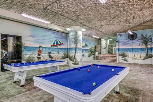 a pool table in a room with a mural at Dunes Village in Myrtle Beach