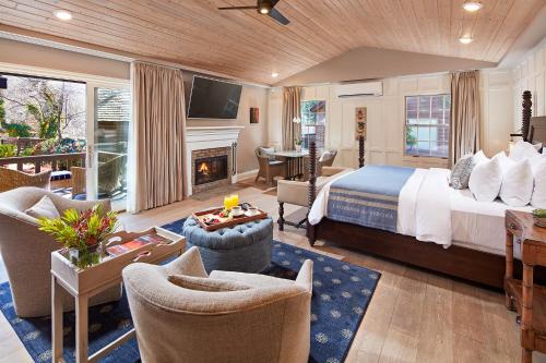a large bedroom with a bed and a fireplace at L'Auberge De Sedona in Sedona