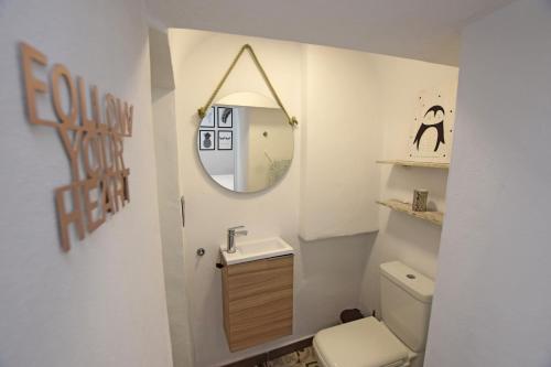 a bathroom with a sink and a mirror at CASA COCO in Vejer de la Frontera