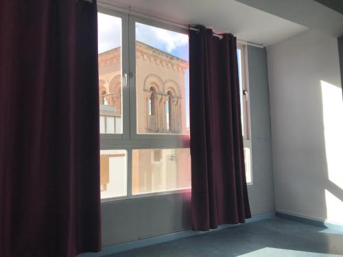 an empty room with a window and a building at Ceibo Ibiza - Guest House in Ibiza Town