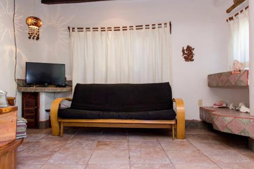 un sofá en una sala de estar con TV en One bedroom Apt In The Heart Of Playa only One block to the Beach!, en Playa del Carmen