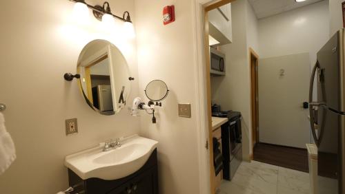 a bathroom with a sink and a mirror at Stay Pittsburgh in Pittsburgh