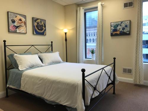 a bedroom with a large bed and a window at Stay Pittsburgh in Pittsburgh