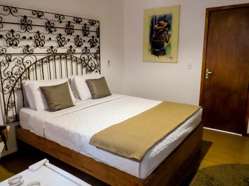 a bedroom with a large bed in a room at Casa Perpetua Hotel D Charm in Manaus