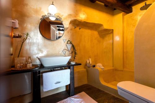 a bathroom with a sink and a mirror at 1822 Makrinitsa Suites in Makrinitsa