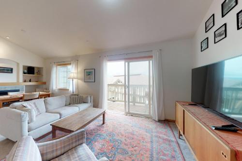 a living room with a couch and a flat screen tv at Steamboat Springs 1308 in Steamboat Springs