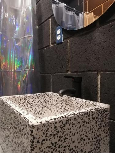 a bathroom sink with a leopard print counter at CÁLIDO COSMOS HOTEL in Cholula