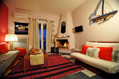 a living room with a couch and a fireplace at Studio Maistros in Galaxidi